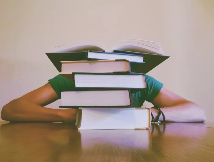 Girl behind books