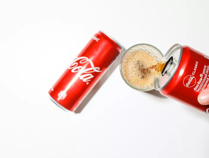 Pouring a can of Coke