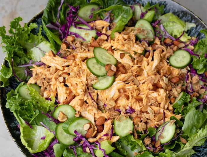 crispy chicken with leafy greens in bowl