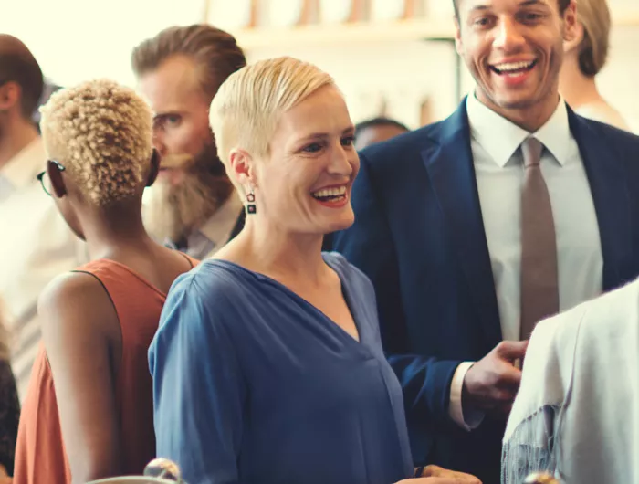 crowd of people talking and smiling