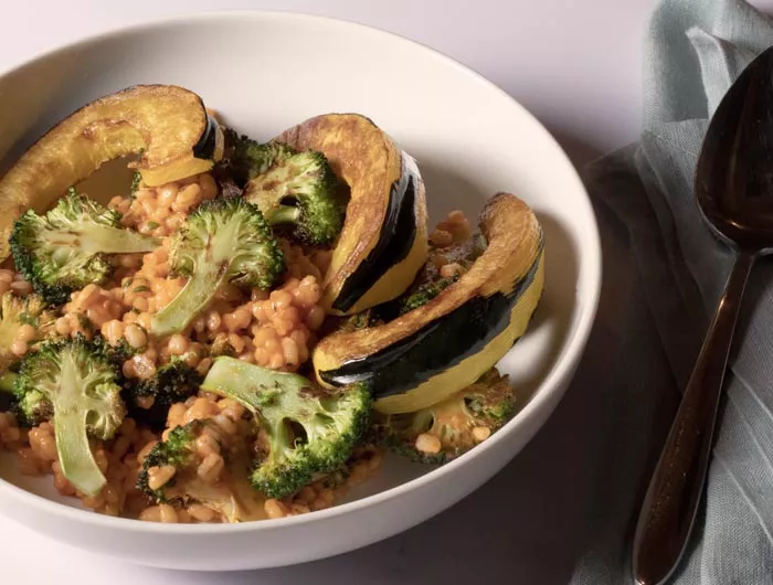 grains, broccoli, and other vegetables in white bowl
