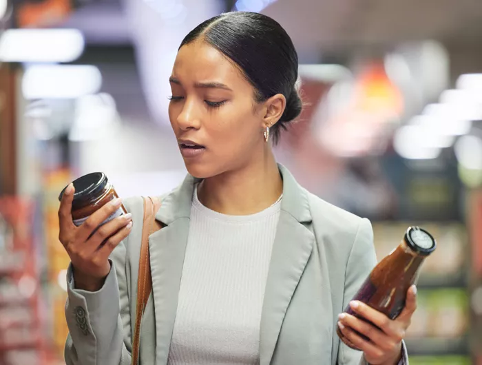 A woman reading food item packaging