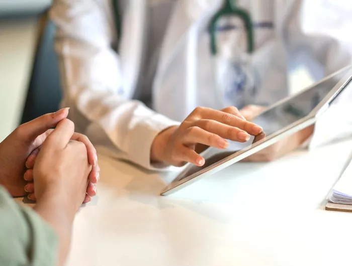 doctor and patient looking at a tablet