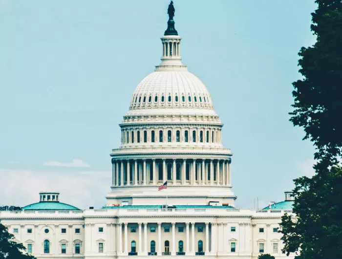 U.S. Capitol Building with a hazy blue sky in the background