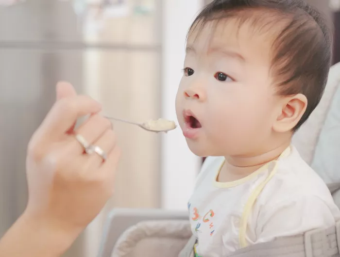 Baby being fed baby food