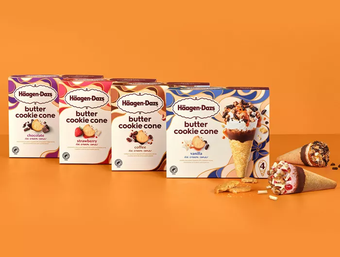 boxes of all 4 flavors of cookie cones on an orange background