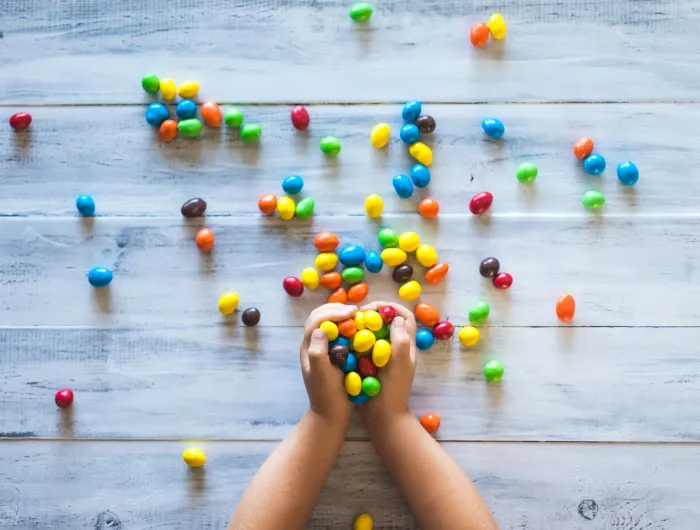 Child's hands overflowing with M&Ms