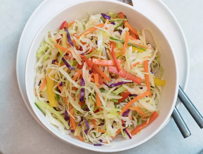 bowl filled with moo shu vegetables and chop sticks