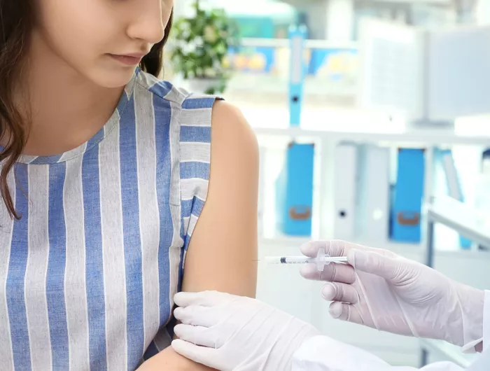 young woman receiving vaccine
