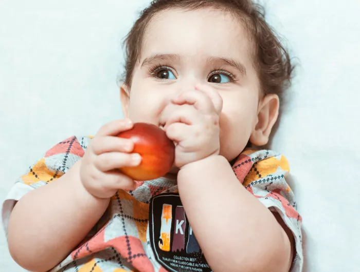 Toddler eating a nectarine