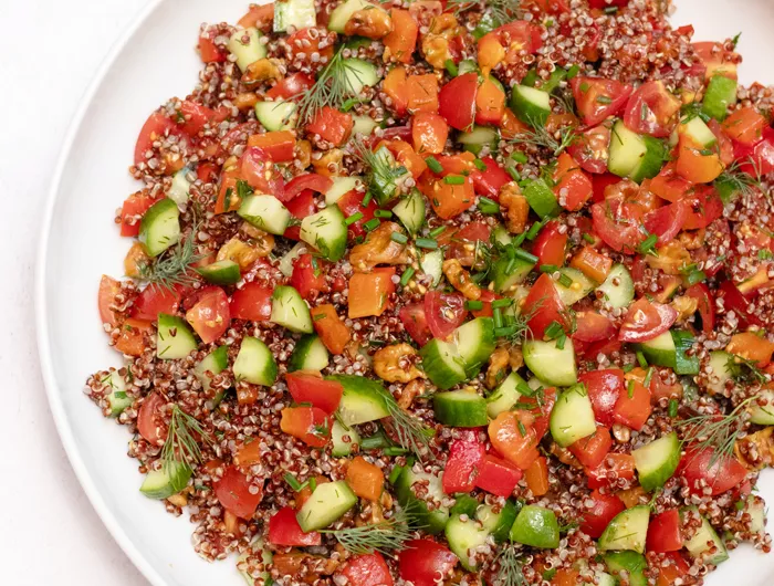 bowl of quinoa, with other chopped vegetables and herbs