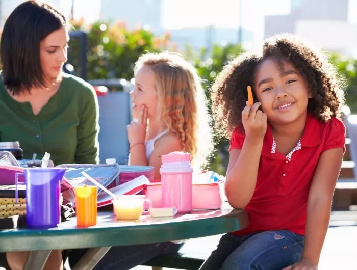 Children eating healthy snacks and lunch at school