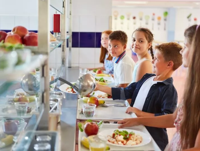 Children wait in line for a healthy school meal. In California, synthetic food dyes could soon be banned from foods sold in schools