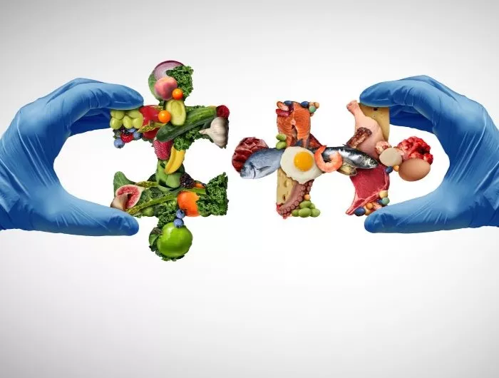 Nutrition science concept with food-group puzzle pieces held by hands in surgical gloves