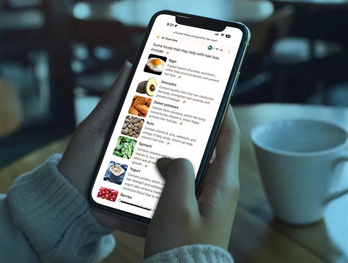 person scrolling on a smart phone in a coffee shop