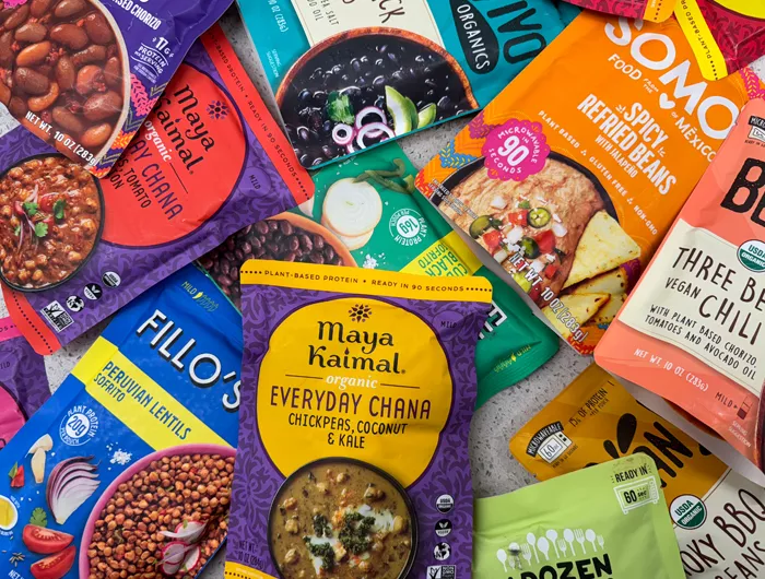 pile of pouches of pre-seasoned beans and lentils