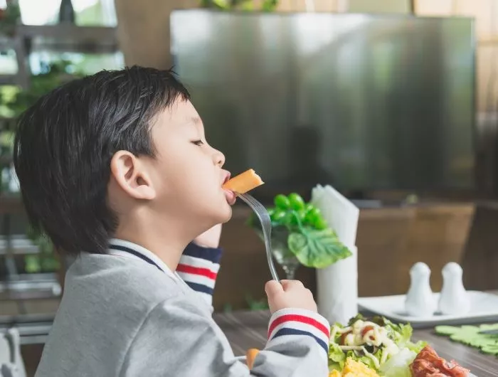 A child eats a healthy meal at a restaurant