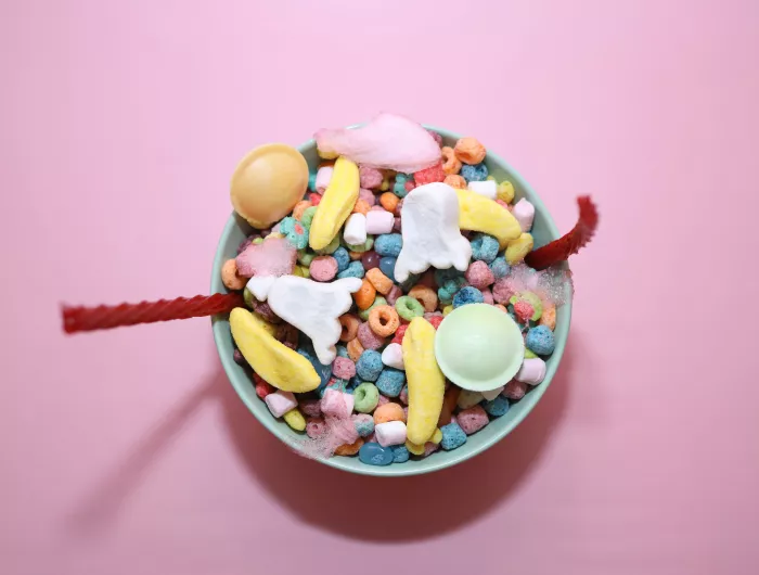 A bowl of colorful cereal, candies, and multi-colored marshmallows 