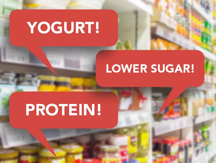 grocery store shelves with red speech bubbles reading "yogurt, lower sugar"protein, lower