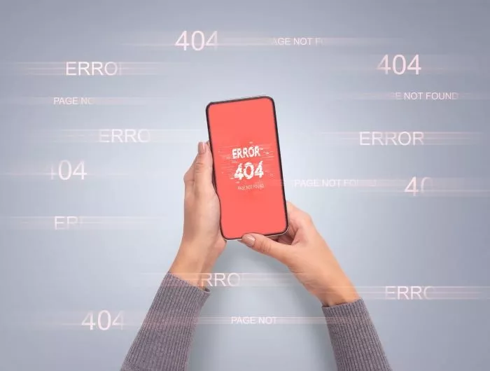 Hands holding smart phone with error 404 or not found icon