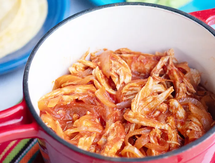 red pot full of pulled chicken 