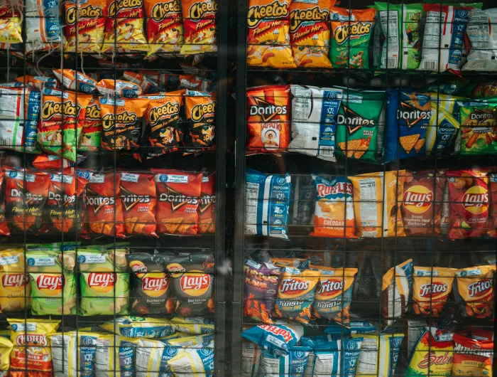 Shelves of assorted chips behind glass.