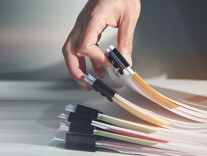 Hand holding report paper