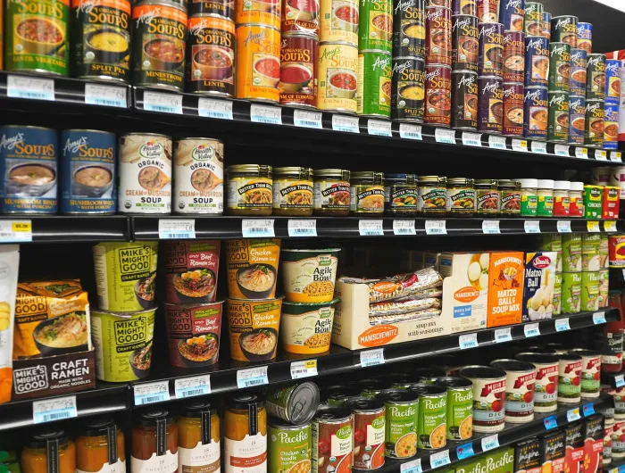 A grocery aisle featuring canned and dried soups