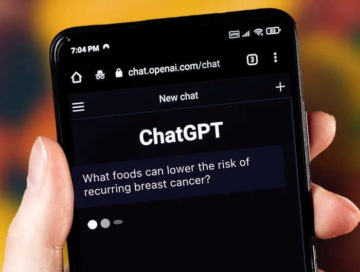 hand holding smart phone that says "ChatGPT" on screen