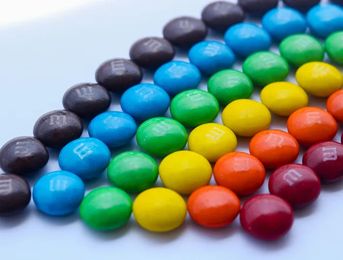 M&Ms candy arranged by color to resemble a rainbow