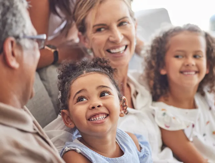 3 generations of women smiling at each other