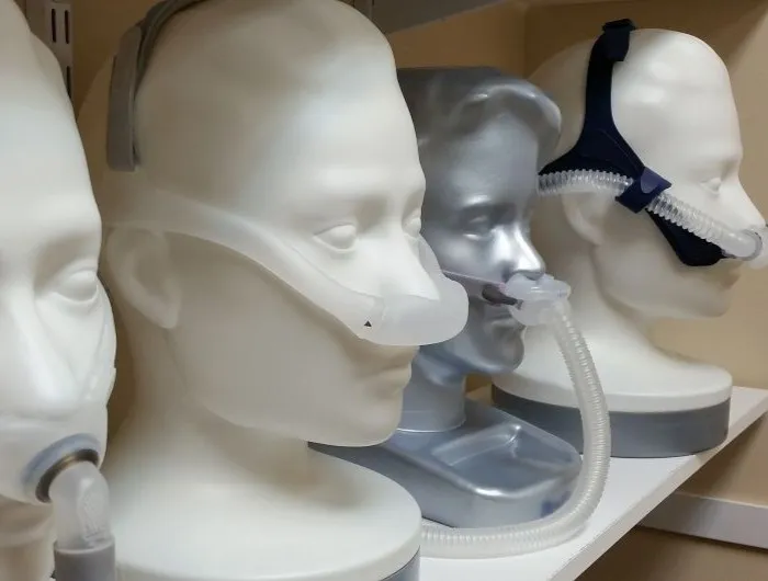 Model heads wearing various CPAP machines