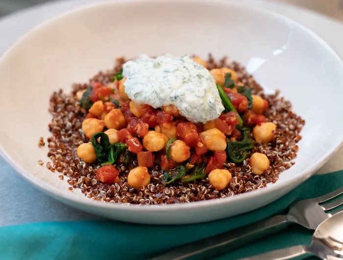 white bowl with chickpea sew topped with yourt