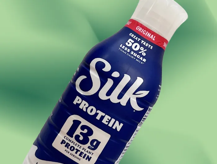 Silk protein milk on green background