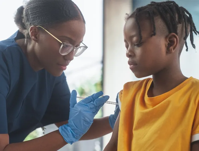 doctor giving child a vaccine in arm