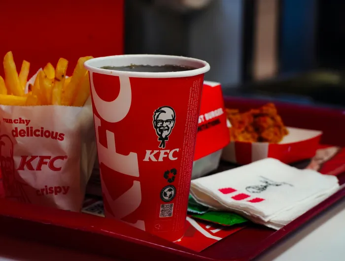 A KFC meal prominently featuring a fountain soda