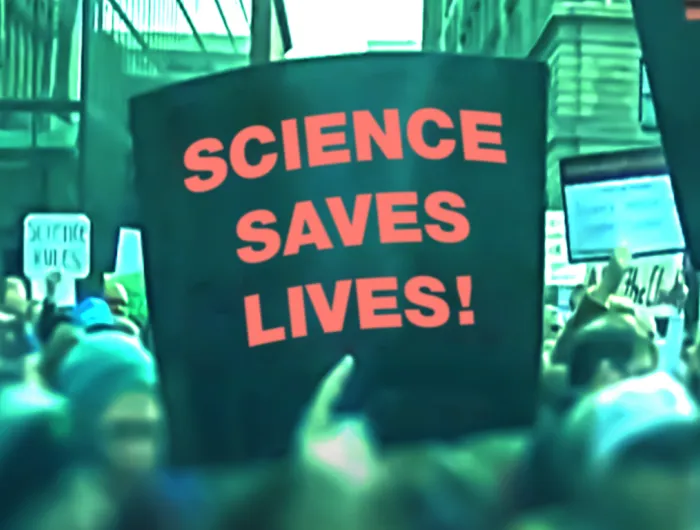 Sign held up at a rally that says, "Science saves lives!"