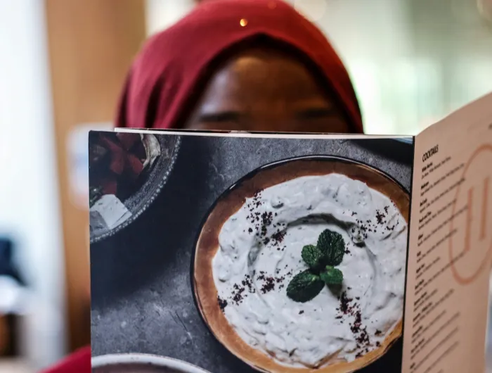 A woman reading a menu.