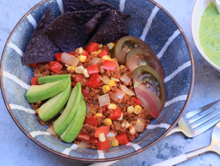 striped blue bowl with chopped vegies and avocado