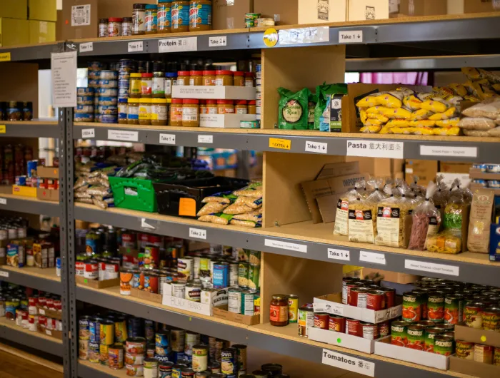Food bank shelves containing dried and canned goods