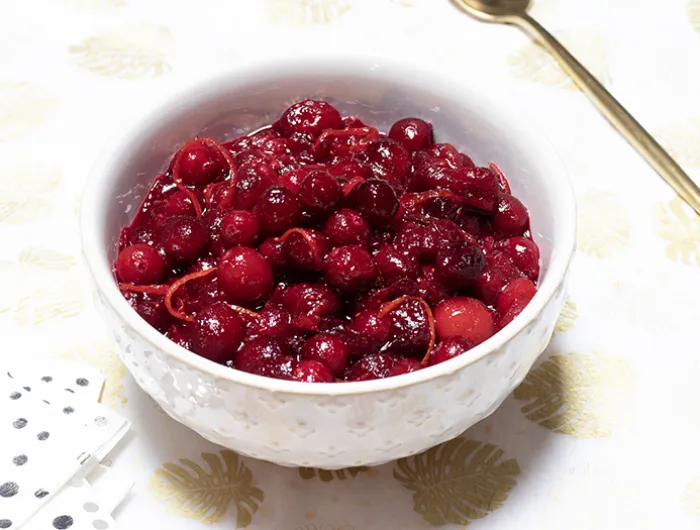 bowl filled with cranberries and sauce