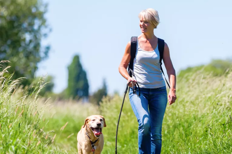 a woman walking her dog