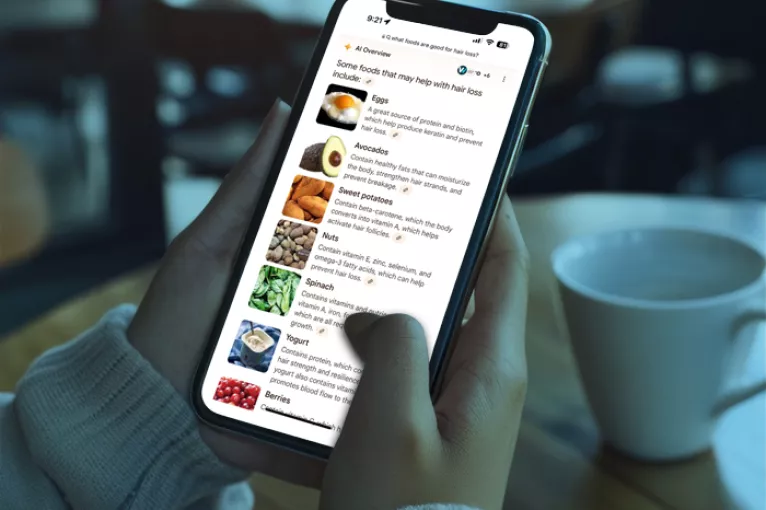 person scrolling on a smart phone in a coffee shop