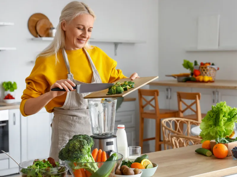 woman blending and chopping vegetables