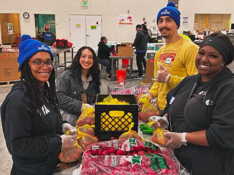Bay Area Community Resources participants packaging food.