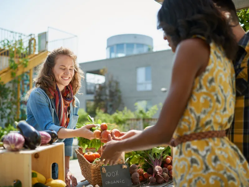 women buying and selling at a farmer's market