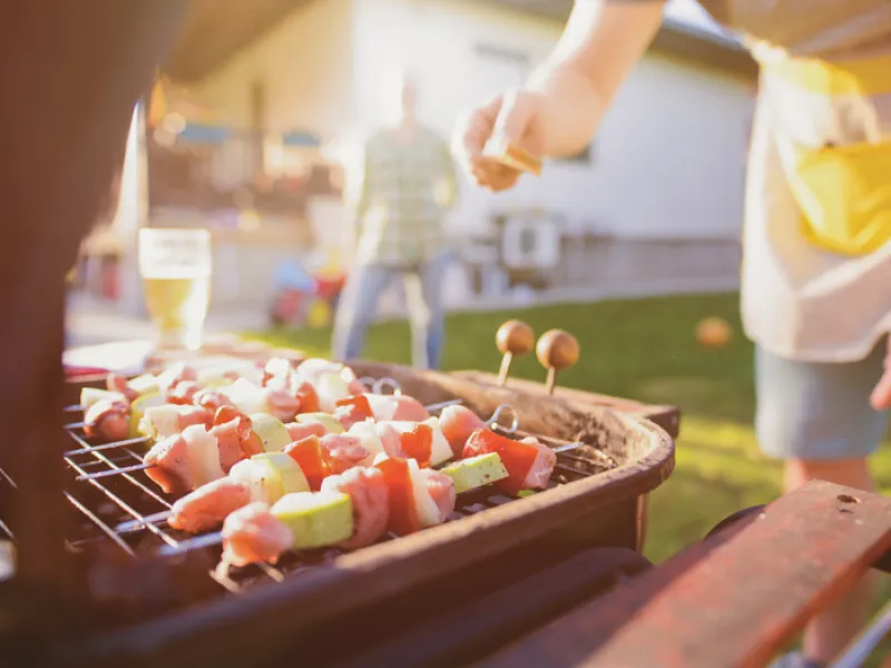 person grilling in evening sunlight