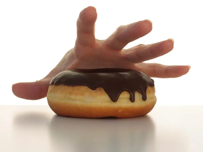 Handing reaching for a donut