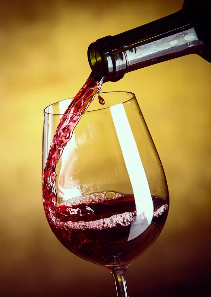 red wine pouring into a glass