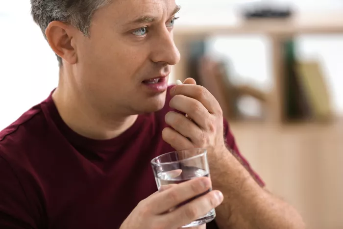 a man taking a pill